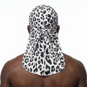 Snow Leopard spotted animal print Satin Silky Durag worn by male model, back view showing tied wrap and tail