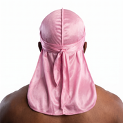 Premium Powder Pink Silk Durag worn by male model, back view showing tied wrap and tail