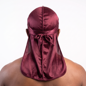 Premium Wine Red Silk Durag worn by male model, back view showing tied wrap and tail
