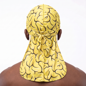 Yellow Brains graphic Satin Silky Durag worn by male model, back view showing tied wrap and tail
