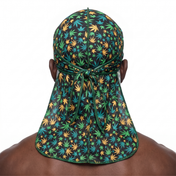Cannabis Orange Green leaf print Satin Silky Durag worn by male model, back view showing tied wrap and tail