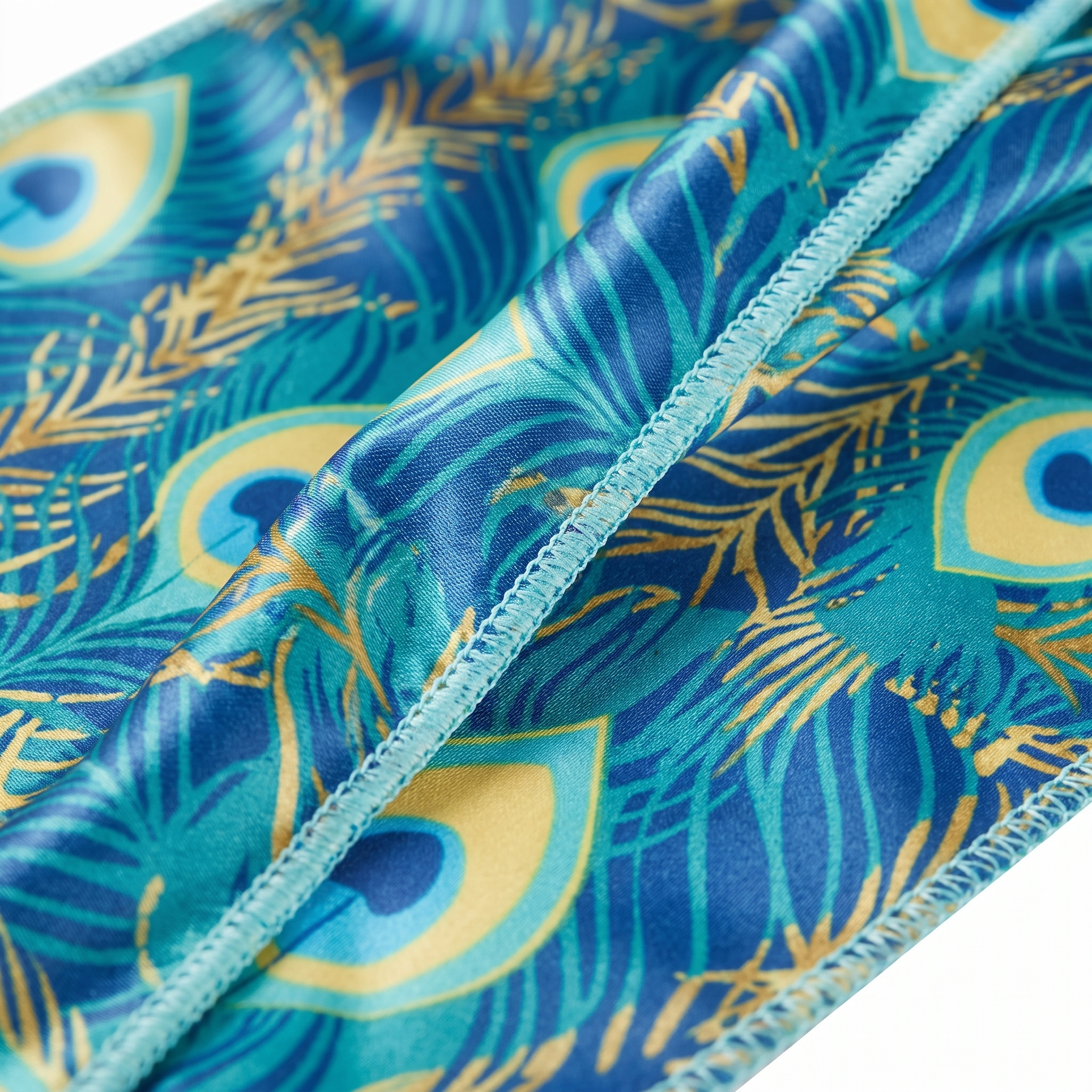 Peacock Bright feather Satin Silky Durag fabric close-up showing Peacock Bright feather print and stitching detail