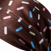 Dark brown ice cream sprinkle Satin Silky Durag fabric close-up showing Dark brown ice cream sprinkle print and stitching detail
