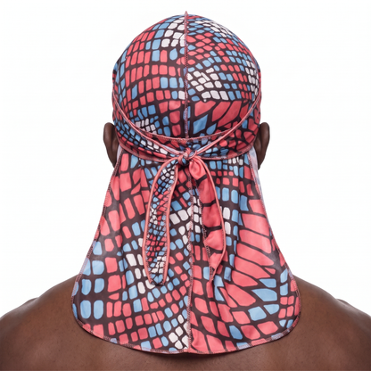 Red and Blue reptile snakeskin Satin Silky Durag worn by male model, back view showing tied wrap and tail