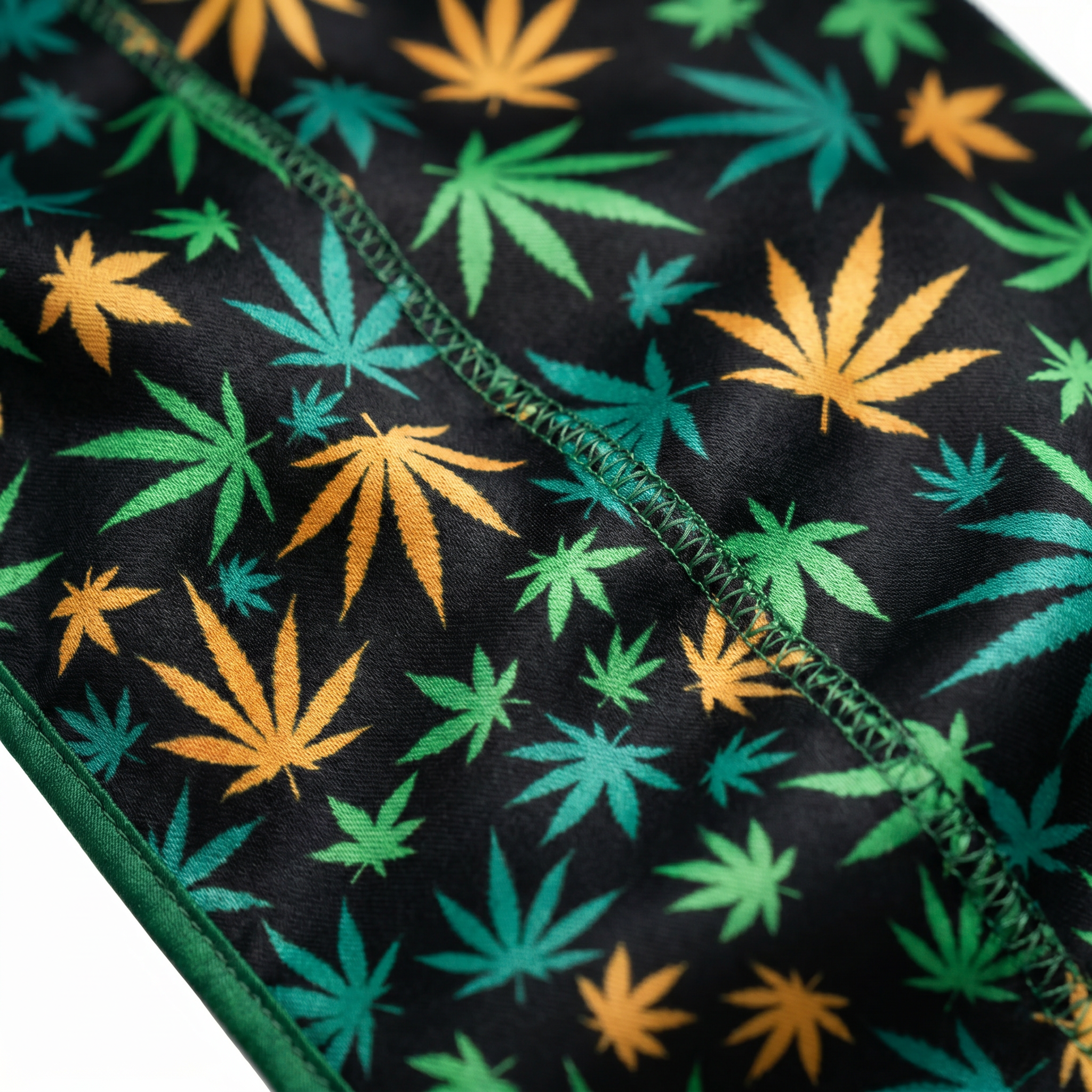 Cannabis Orange Green leaf print Satin Silky Durag fabric close-up showing Cannabis Orange Green leaf print print and stitching detail