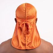 Premium Silk Durag Orange worn by male model, back view showing tied wrap and tail