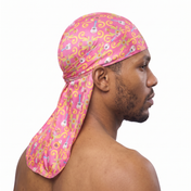 Cinco De Mayo Pink festive Satin Silky Durag worn by male model, side profile showing fit and tail drape