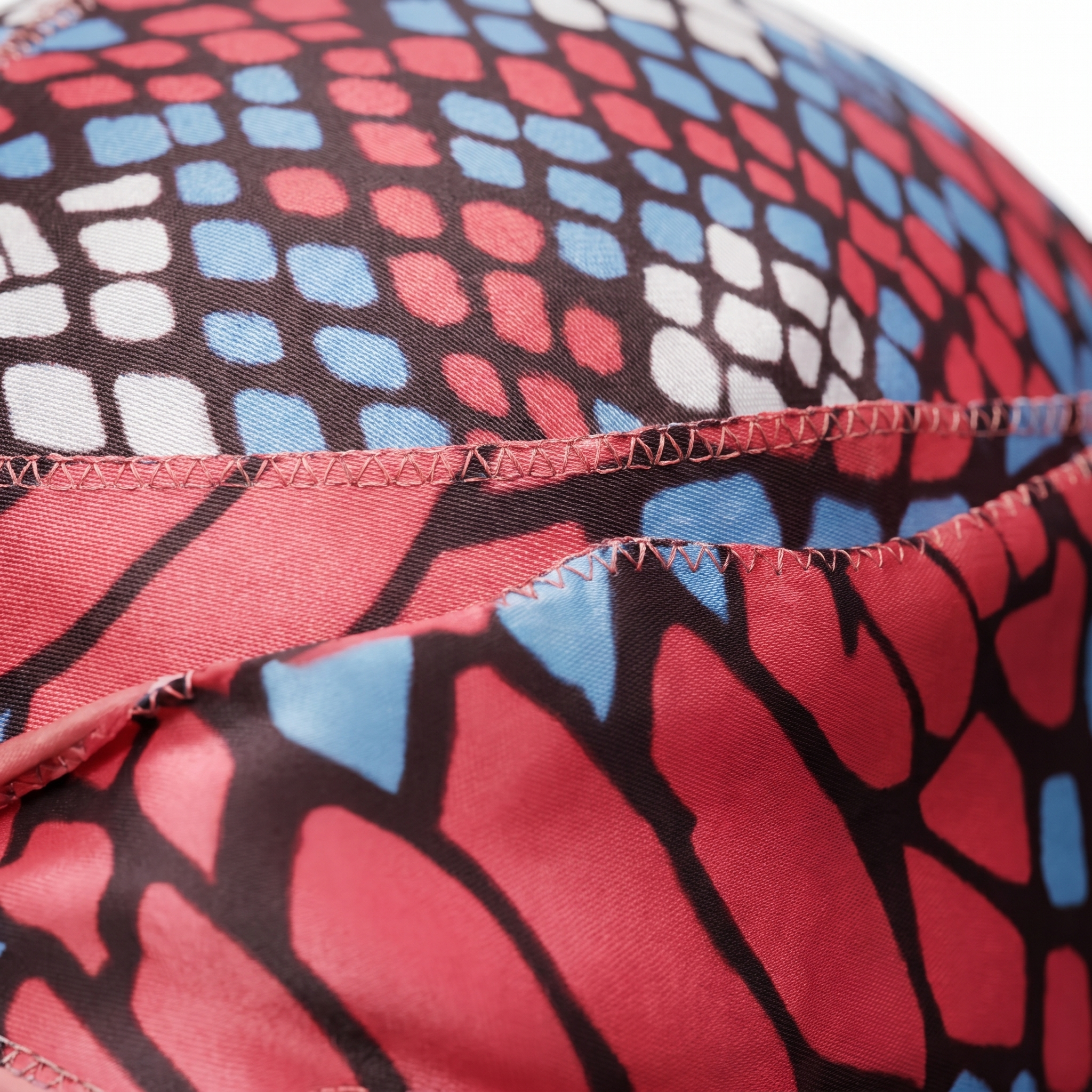 Red and Blue reptile snakeskin Satin Silky Durag fabric close-up showing Red and Blue reptile snakeskin print and stitching detail
