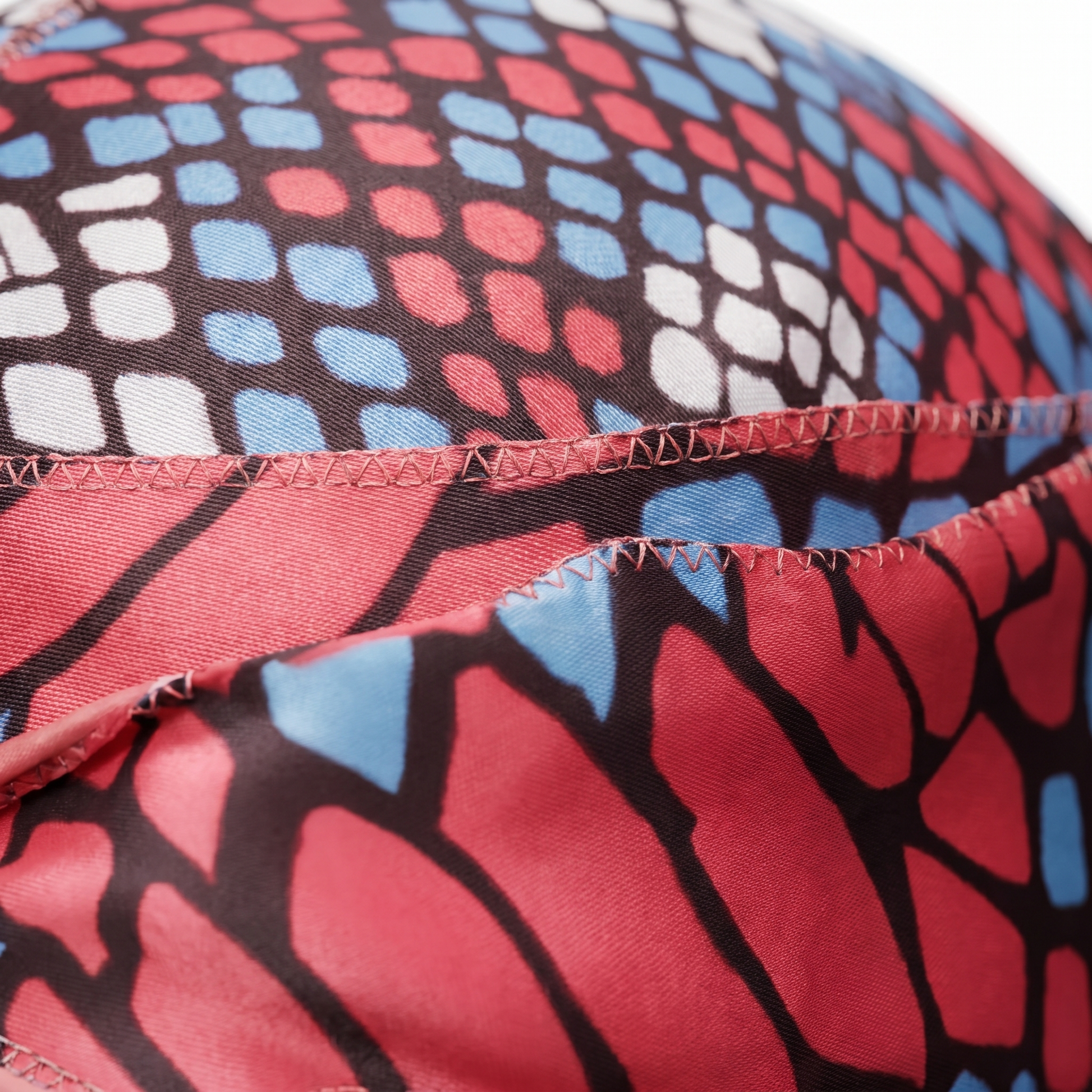 Red and Blue reptile snakeskin Satin Silky Durag fabric close-up showing Red and Blue reptile snakeskin print and stitching detail