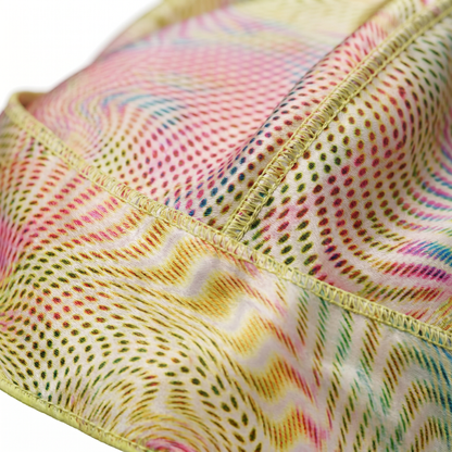 Warm-tone optical illusion swirl Satin Silky Durag fabric close-up showing Warm-tone optical illusion swirl print and stitching detail