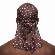 Dark brown ice cream sprinkle Satin Silky Durag worn by male model, back view showing tied wrap and tail