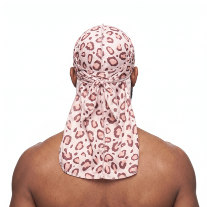 Pink leopard animal print Satin Silky Durag worn by male model, back view showing tied wrap and tail
