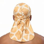 Giraffe animal print Satin Silky Durag worn by male model, back view showing tied wrap and tail