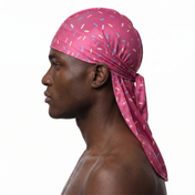 Dark pink ice cream sprinkle Satin Silky Durag worn by male model, side profile showing fit and tail drape