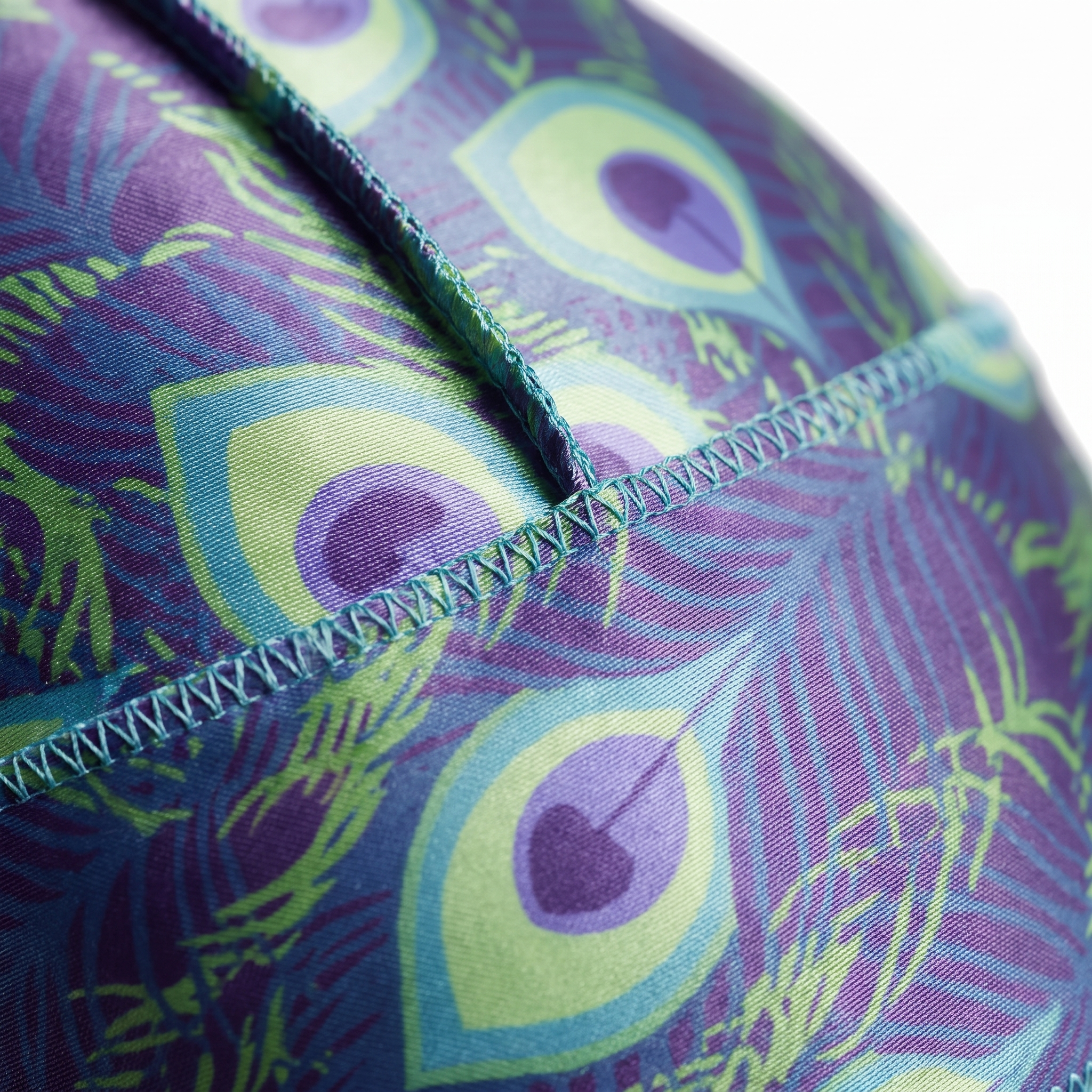 Peacock Shade feather Satin Silky Durag fabric close-up showing Peacock Shade feather print and stitching detail