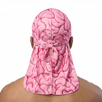 Pink Brains graphic Satin Silky Durag worn by male model, back view showing tied wrap and tail