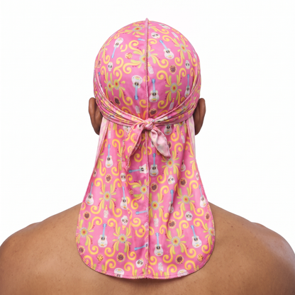 Cinco De Mayo Pink festive Satin Silky Durag worn by male model, back view showing tied wrap and tail