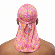 Cinco De Mayo Pink festive Satin Silky Durag worn by male model, back view showing tied wrap and tail