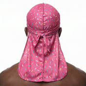 Dark pink ice cream sprinkle Satin Silky Durag worn by male model, back view showing tied wrap and tail