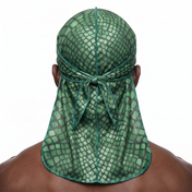 Green reptile snakeskin Satin Silky Durag worn by male model, back view showing tied wrap and tail