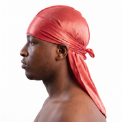 Premium Coral Red Silk Durag worn by male model, side profile showing fit and tail drape
