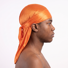 Premium Silk Durag Orange worn by male model, side profile showing fit and tail drape
